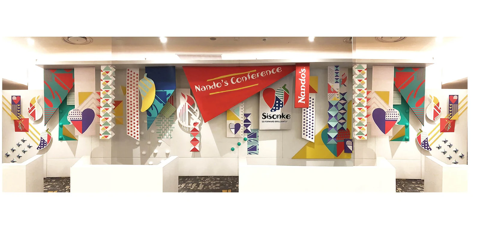A Nando's conference booth dressed with paper decor